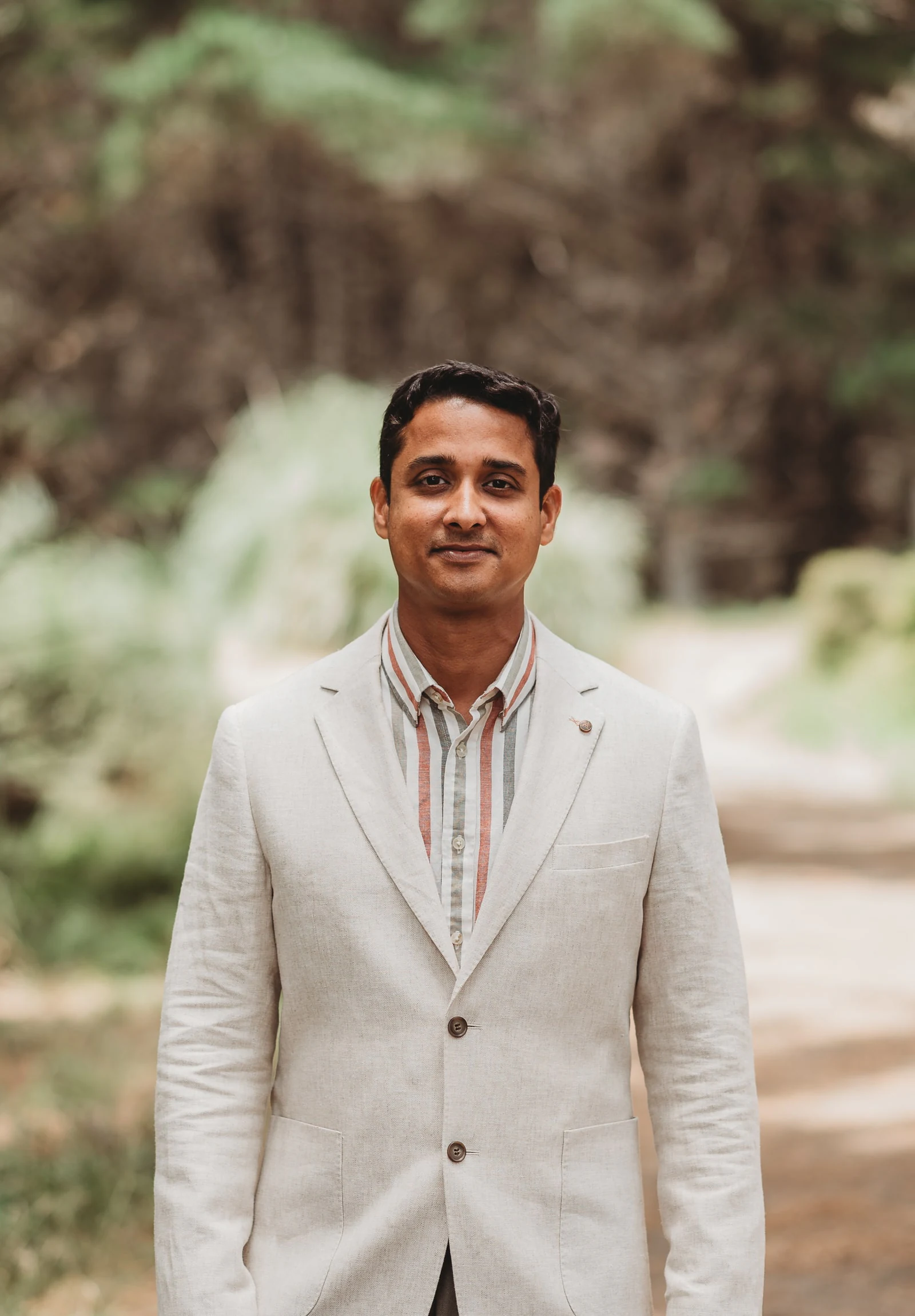 Sravan Bade, founder of Reflekt Design, photographed outdoors in a light linen jacket