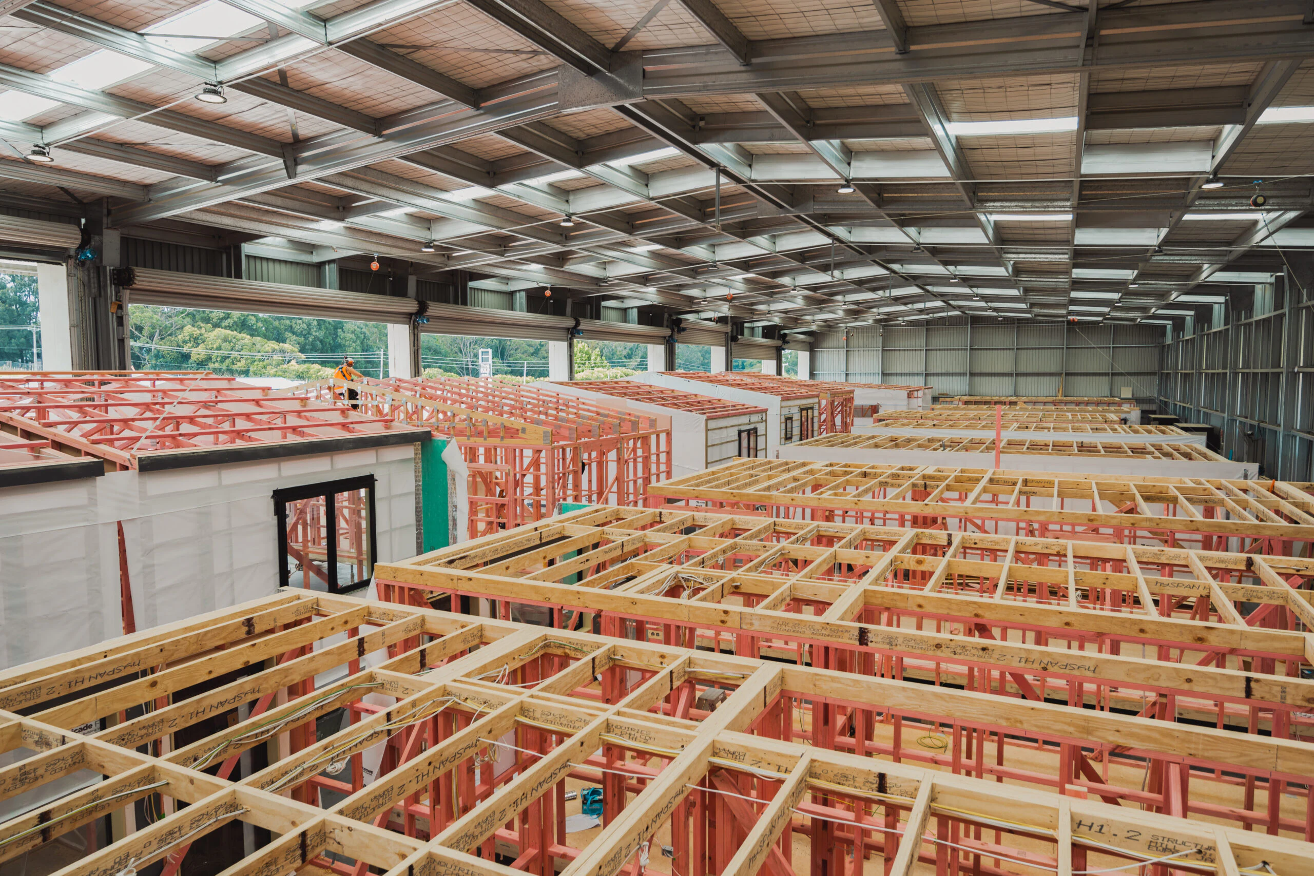 Multiple two-storey home modules under construction side by side inside Transbuild's Drury manufacturing facility